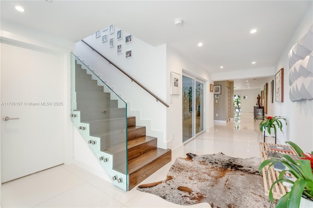 stairway featuring tile patterned flooring