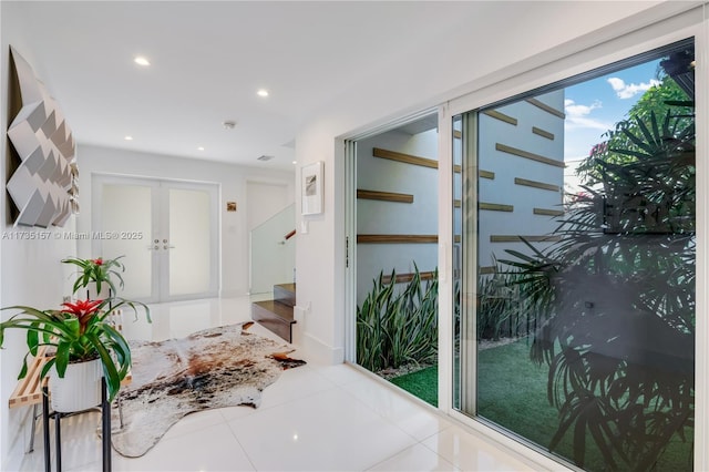 hall featuring french doors and light tile patterned floors