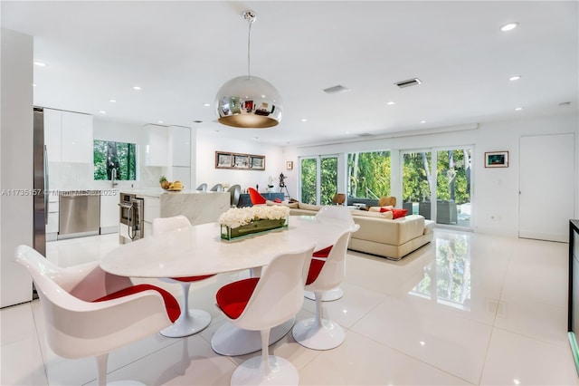 tiled dining space featuring plenty of natural light