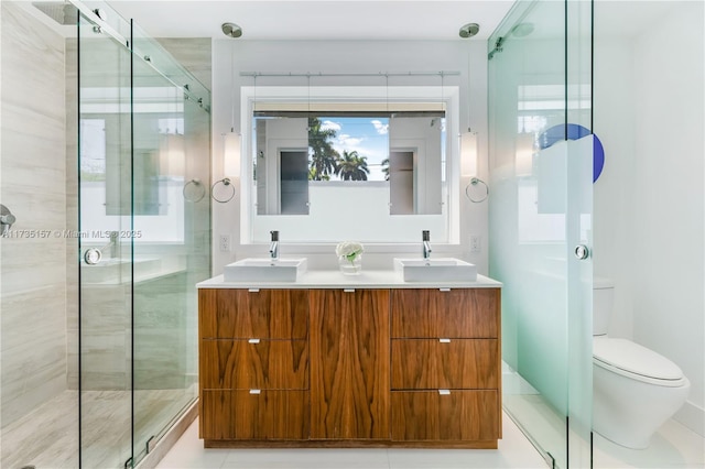 bathroom featuring walk in shower, vanity, toilet, and tile patterned flooring