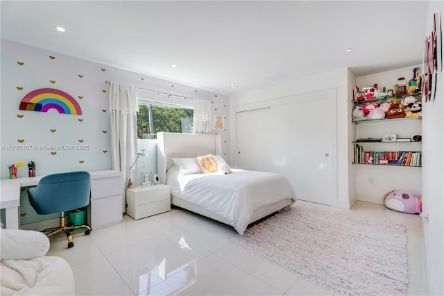 bedroom featuring a closet and light tile patterned floors