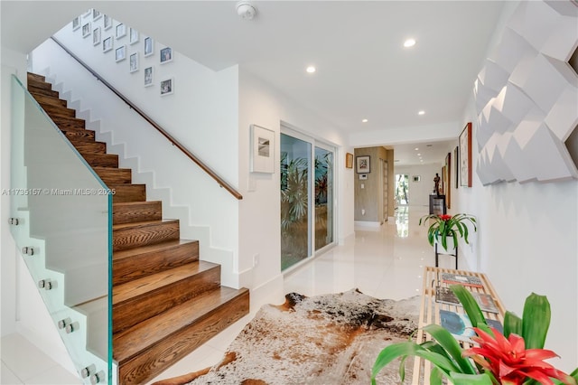 staircase featuring tile patterned flooring