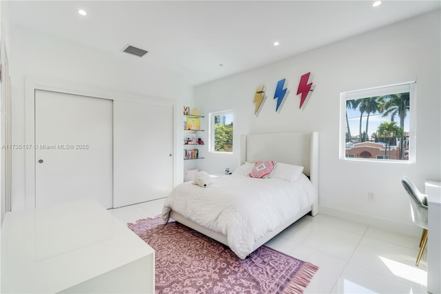 tiled bedroom with a closet