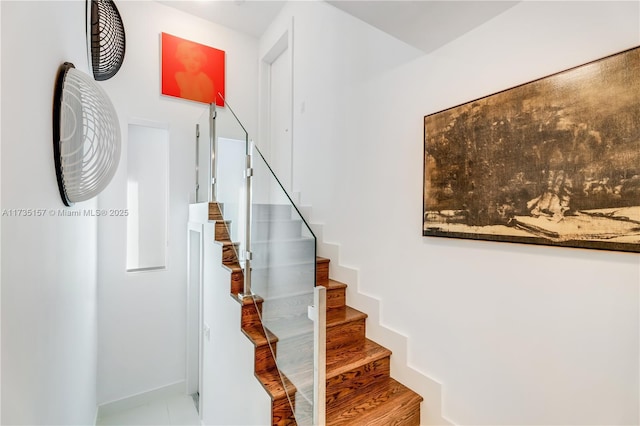 staircase featuring wood-type flooring