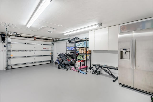 garage featuring stainless steel fridge with ice dispenser