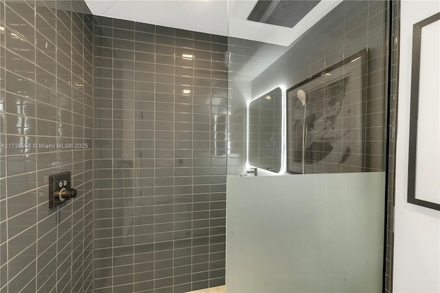 bathroom with a tile shower