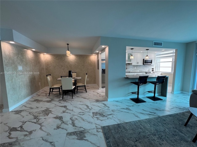 dining room featuring marble finish floor, visible vents, and baseboards