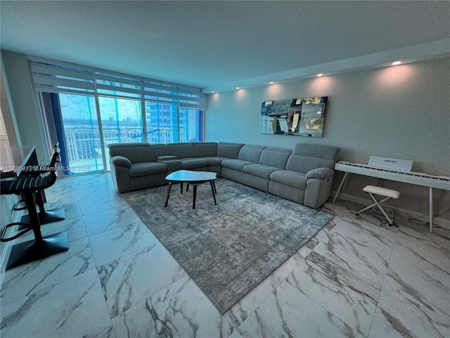 living room featuring a textured ceiling, marble finish floor, and baseboards