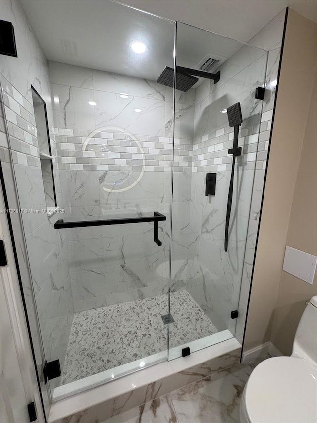 full bath with a marble finish shower, marble finish floor, visible vents, and toilet