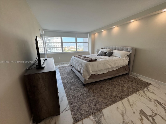 bedroom with marble finish floor and baseboards