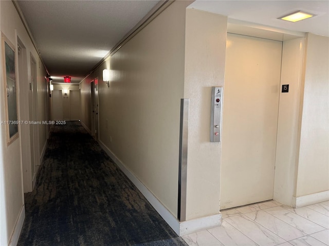 corridor featuring baseboards, marble finish floor, and elevator