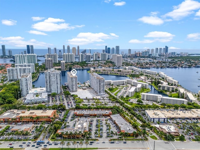 birds eye view of property featuring a city view and a water view