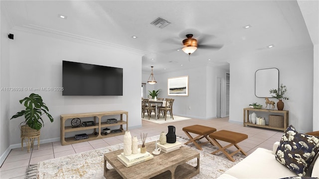 living room featuring ceiling fan, visible vents, light tile patterned flooring, and crown molding