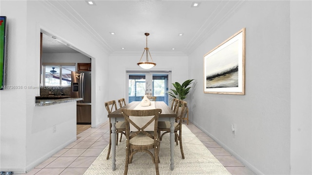 dining area featuring light tile patterned flooring, french doors, crown molding, and baseboards