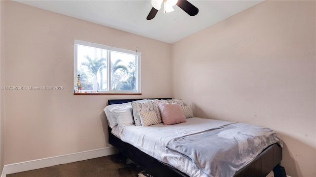 carpeted bedroom featuring a ceiling fan and baseboards