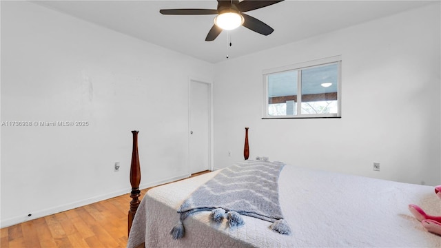 bedroom featuring baseboards, a ceiling fan, and light wood finished floors