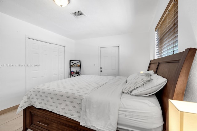 tiled bedroom featuring a closet