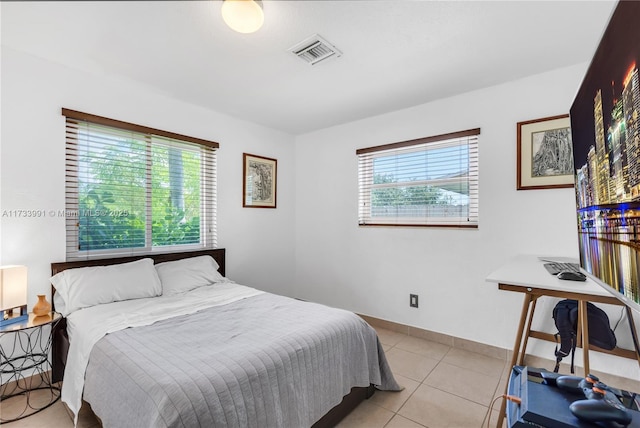 bedroom with light tile patterned floors