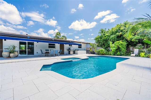 view of pool featuring a patio, area for grilling, and an in ground hot tub