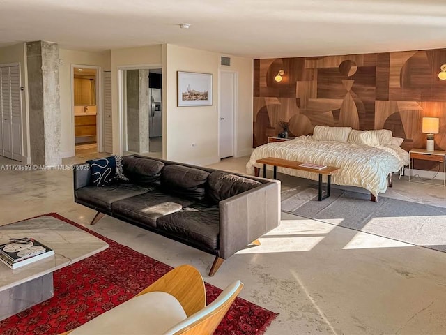 bedroom with stainless steel fridge and wooden walls