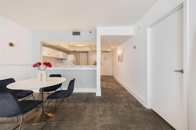 dining room with a raised ceiling