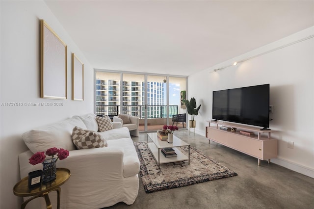 living room featuring a wall of windows and concrete flooring