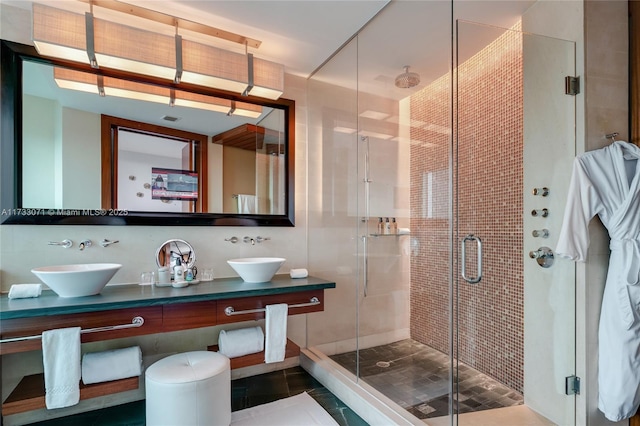 bathroom with vanity, tile walls, and walk in shower