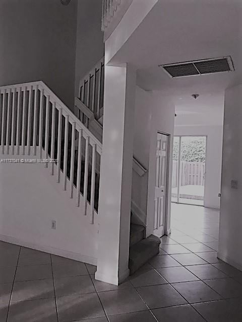 stairway featuring tile patterned flooring