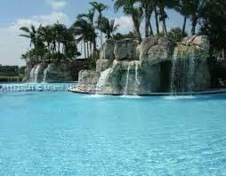 view of pool with a water view