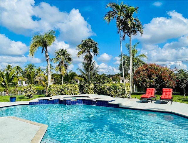 view of swimming pool with a pool with connected hot tub and a patio area