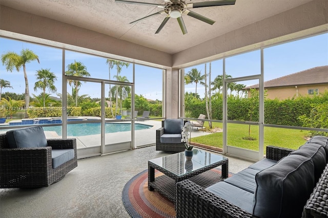 sunroom / solarium featuring a ceiling fan