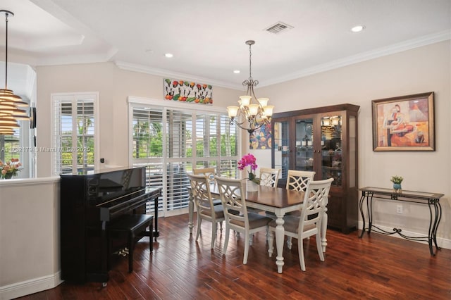 dining area with visible vents, dark wood finished floors, a notable chandelier, and ornamental molding