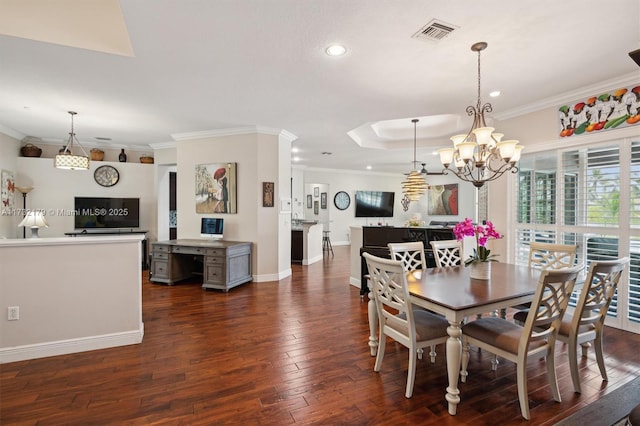 dining room with crown molding, visible vents, a raised ceiling, and dark wood-style flooring