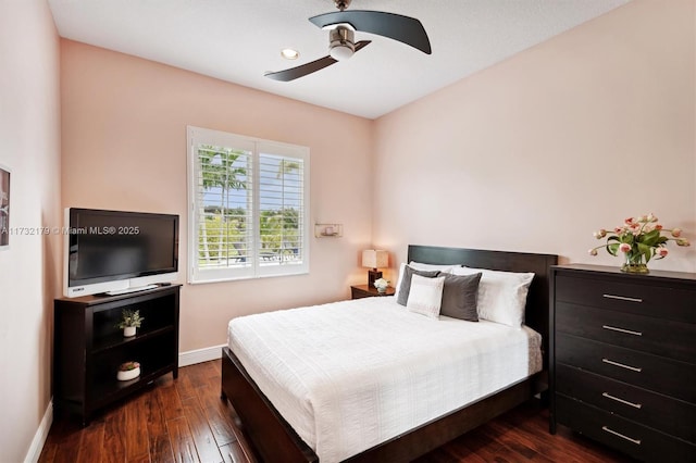 bedroom featuring dark wood-style floors, ceiling fan, and baseboards