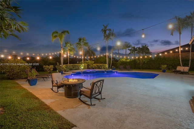 outdoor pool featuring an outdoor fire pit and a patio area