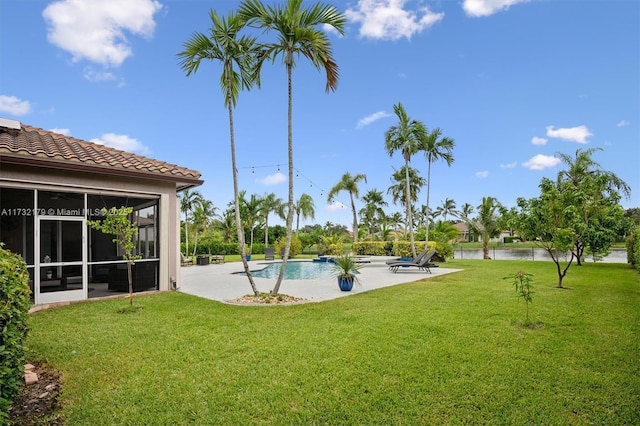 pool featuring a sunroom, a water view, a lawn, and a patio