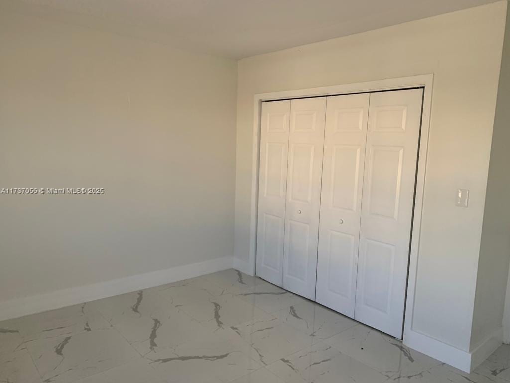 unfurnished bedroom featuring a closet