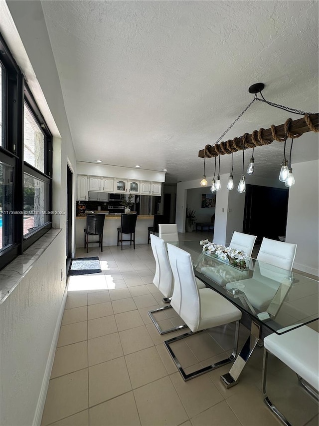 unfurnished dining area with a textured ceiling and light tile patterned floors