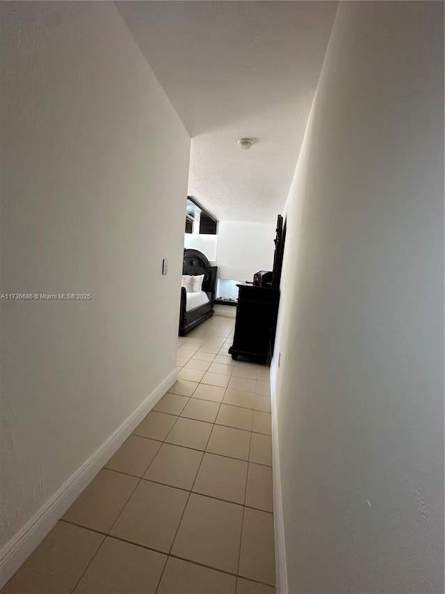 corridor featuring light tile patterned floors