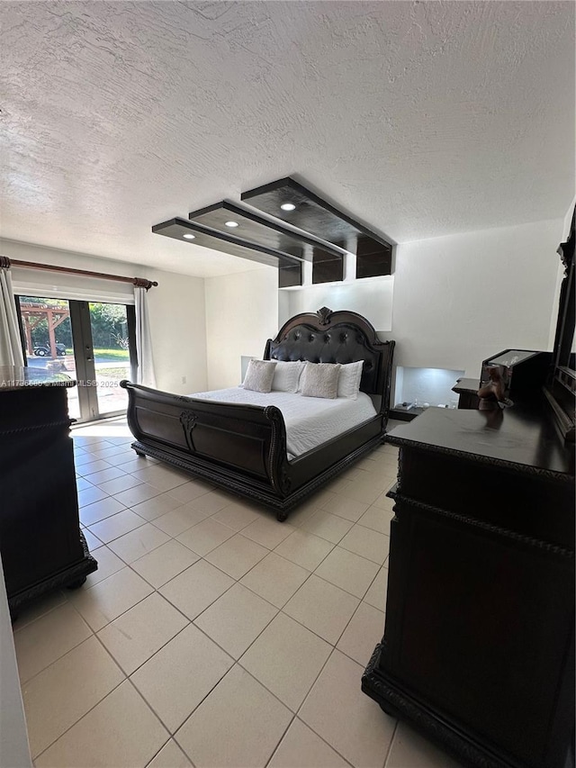 bedroom with french doors, light tile patterned flooring, a textured ceiling, and access to outside