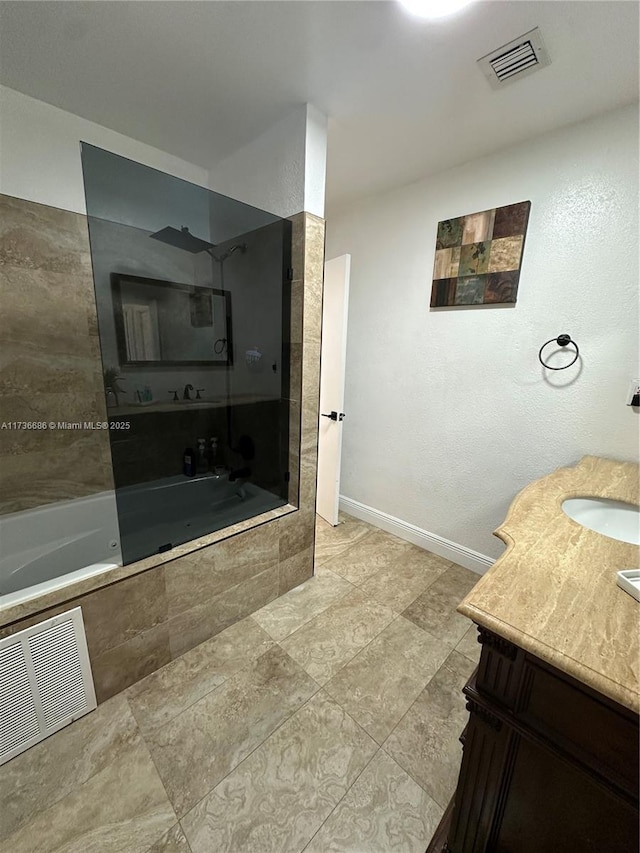 bathroom with vanity and tiled shower / bath combo