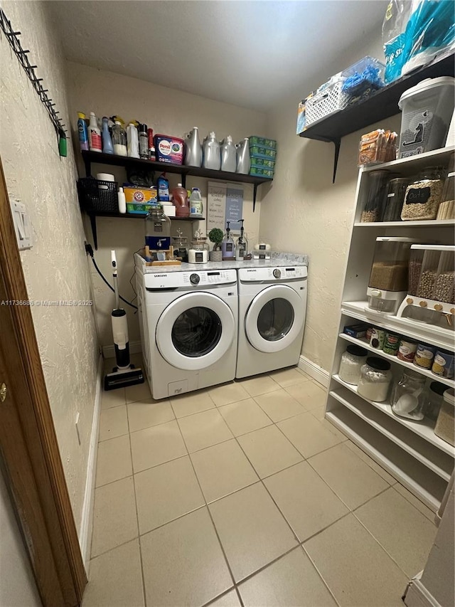 laundry room with light tile patterned floors and washer and dryer