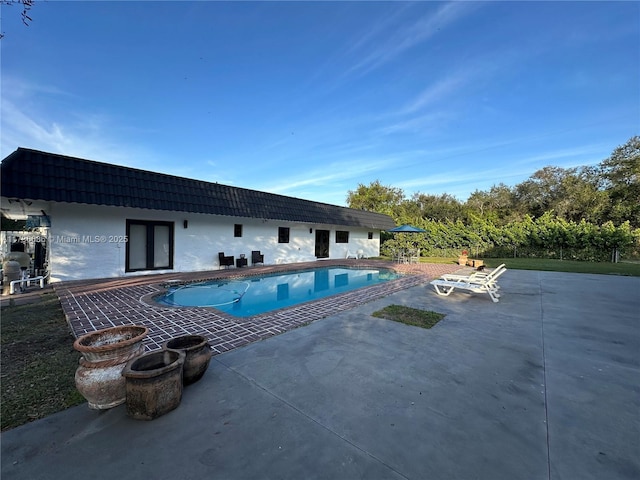 view of swimming pool with a patio area