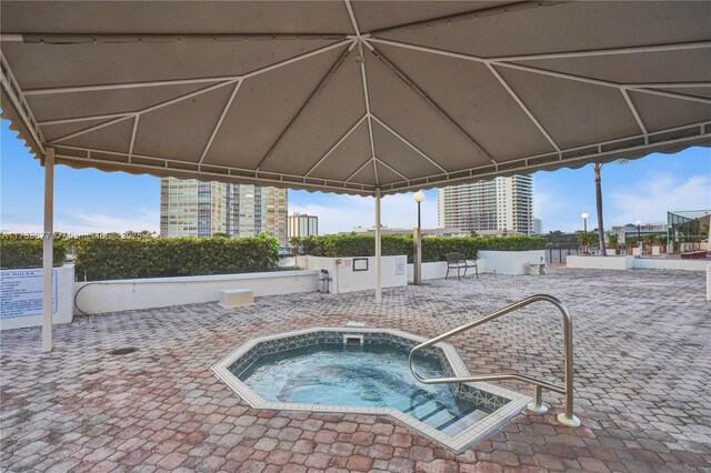 view of pool featuring a community hot tub and a gazebo