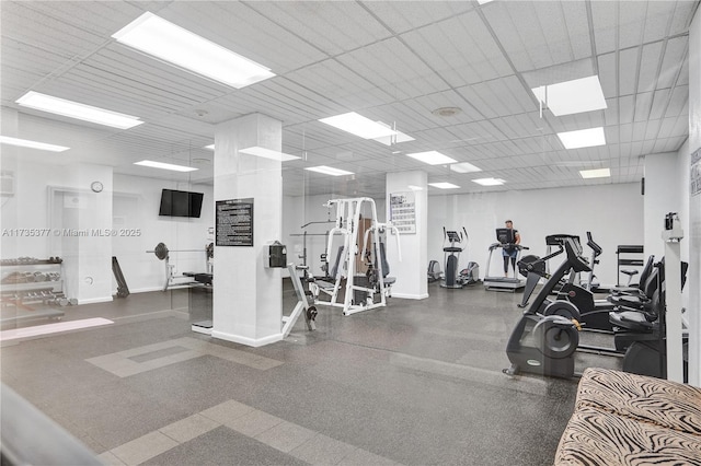 exercise room with a paneled ceiling