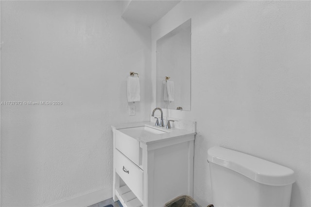 bathroom featuring toilet and vanity