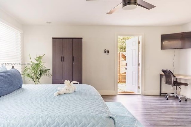 bedroom featuring ceiling fan, wood-type flooring, and multiple windows