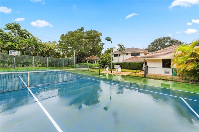 view of swimming pool with tennis court