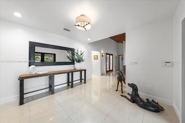 hall with light tile patterned floors