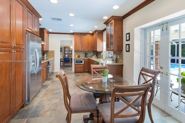 7420 SW 145th Ter, Palmetto Bay, FL 33158 - kitchen featuring ornamental molding, stainless steel appliances, french doors, and plenty of natural light